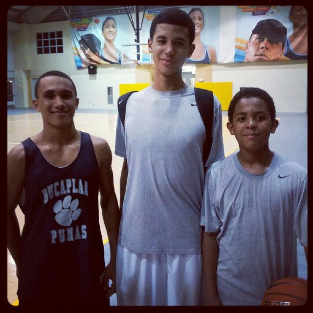Julius on a basketball court with teammates after practice